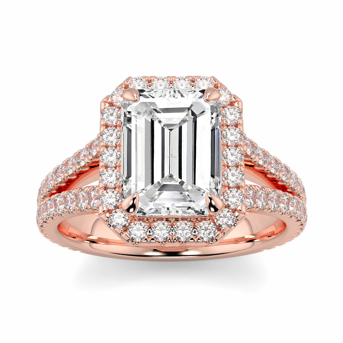 Rose gold ring with emerald-cut diamond and smaller diamonds on a white background Yb jewellers emerald split halo diamond engagement ring