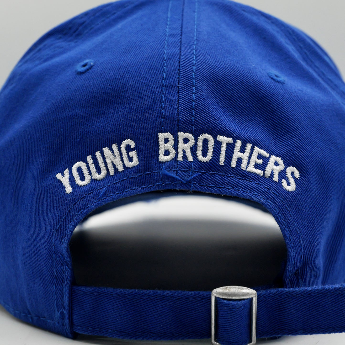 Blue cap with 'YOUNG BROTHERS' embroidery on a gray background