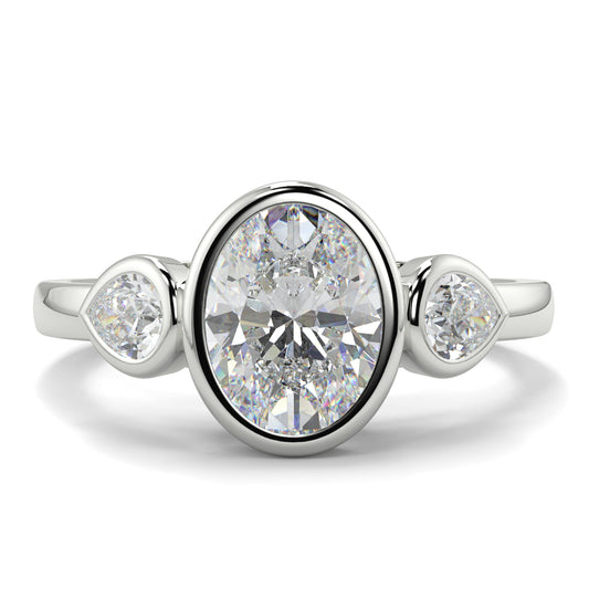 Diamond ring with three diamonds on a white background oval and pear diamond trilogy ring yb jewellers best selling design and engagement rings 