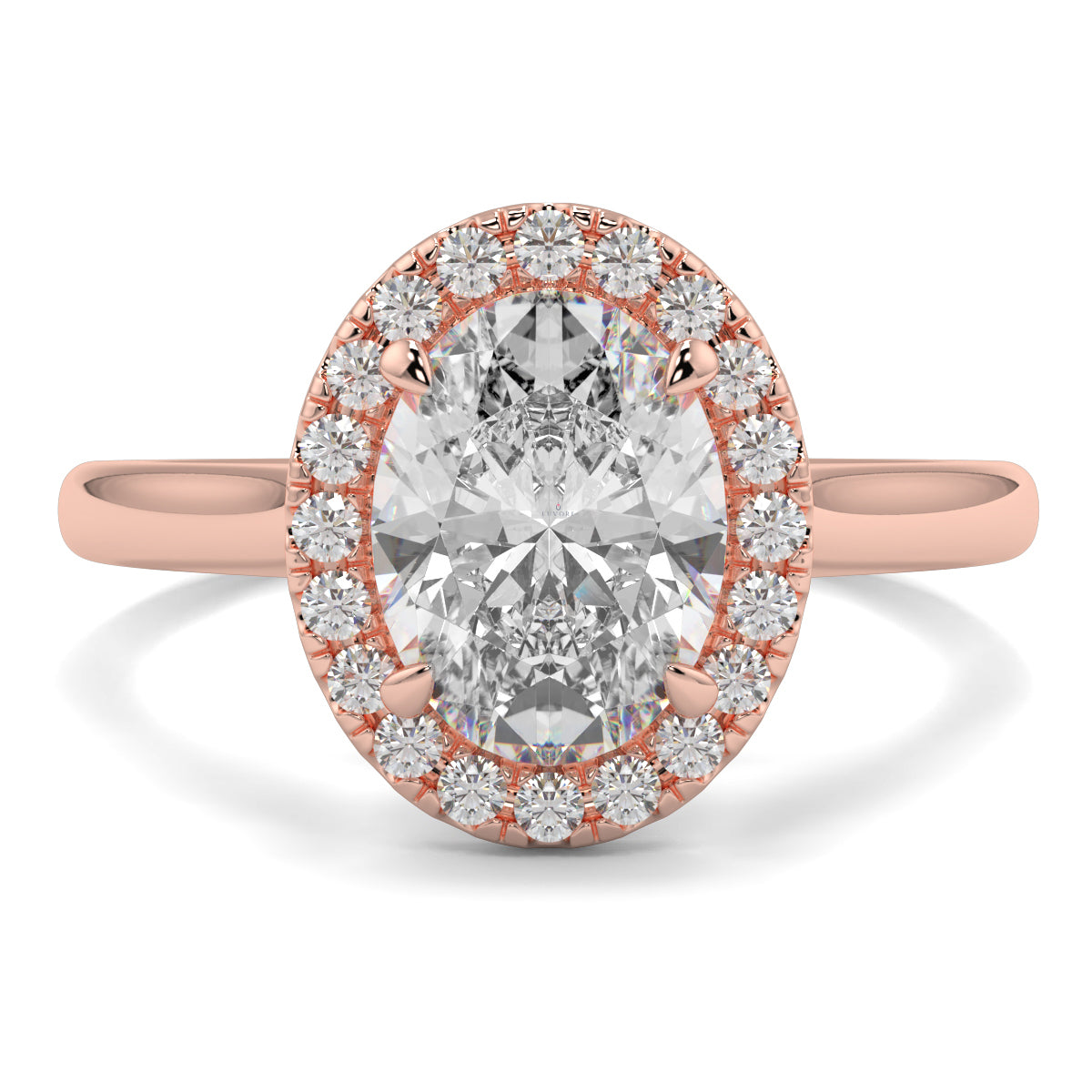 Rose gold ring with a large diamond and smaller diamonds around on a white background yb jewellers iamond halo with plain shoulder oval shape 