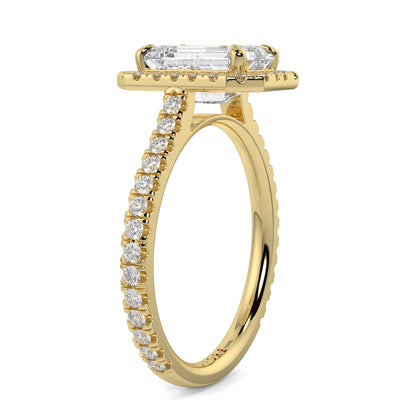 Gold ring with emerald-cut diamond and smaller diamonds on a white YB_Jewellers_Engagement_Ringbackground