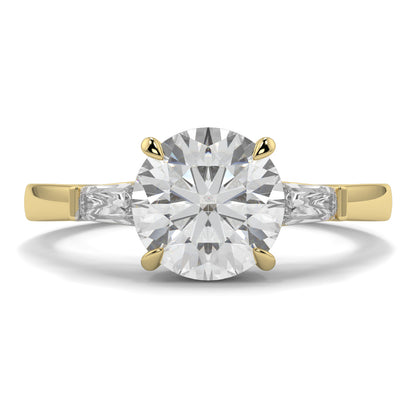 Gold ring with a large diamyb_jewellers_3_stone_trilogy_engagement_ring_round_and_pear_shape_best_selling_design_trending_diamond_ringond on a white background 