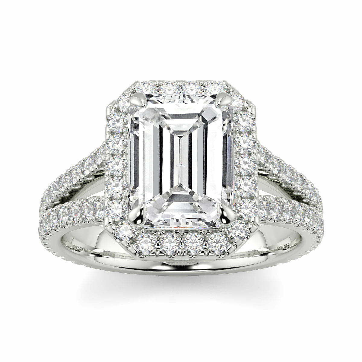 Diamond ring with emerald-cut center stone on a white background Yb jewellers emerald split halo diamond engagement ring 