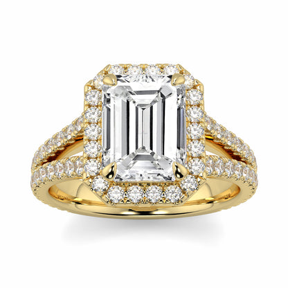 Gold ring with emerald-cut diamond and smaller diamonds on a white background Yb jewellers emerald split halo diamond engagement ring 