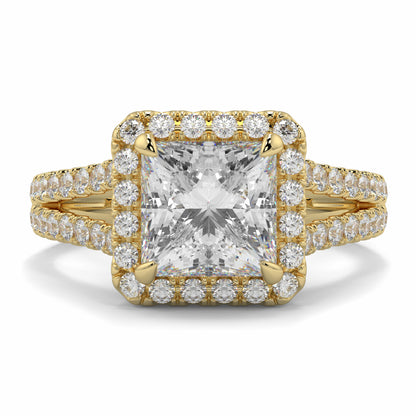 Gold ring with a large central diamond and smaller diamonds around on a white background yb jewellers twist halo princess shape engagement diamond ring best selling design ring and trending design 2026
