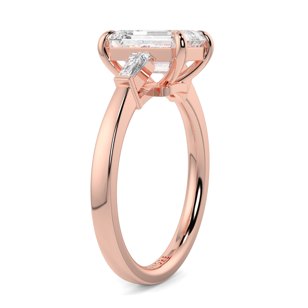 Rose gold ring with a large diamond and smaller diamonds on a white yb_jewellers_3_stone_trilogy_engagement_ring_round_and_pear_shape_best_selling_design_trending_diamond_ringbackground