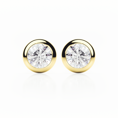 Gold earrings with clear gemstones on a white background