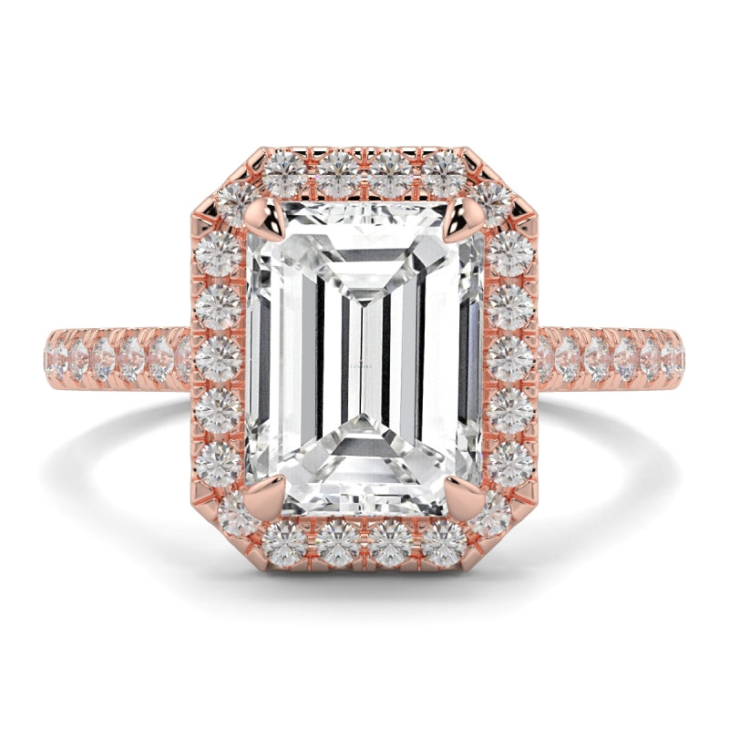 Rose gold ring with emerald-cut diamond and smaller diamonds on a white background YB_Jewellers_Engagement_Ring
