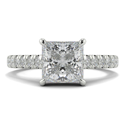 Diamond ring with a prominent central gemstone and smaller stones on the band against a white background Yb jewellers engagement ring straight band