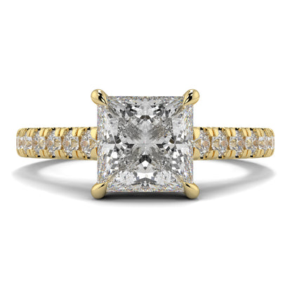 Gold ring with a large diamond and smaller diamonds on the band against a white background Yb jewellers engagement ring straight band
