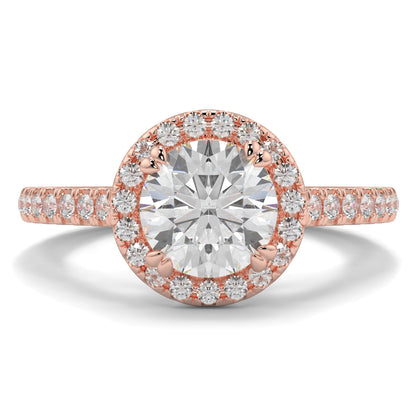 Rose gold ring with a large diamond and smaller diamonds around on a white background round diamond halo engagement ring yb jewellers tiger claws vintage style