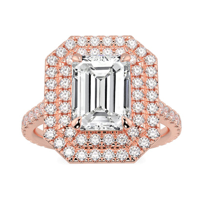 Rose gold ring with emerald-cut diamond and smaller diamonds on a white background yb jewellers best selling ring designs emerald diamond double halo