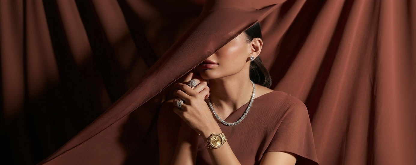 Woman wearing jewelry peeking from behind a curtain