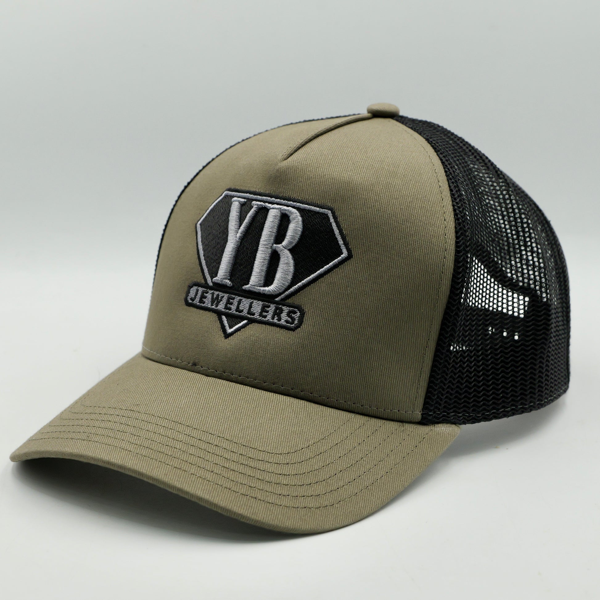 Khaki cap with black mesh and YB Jewelers logo on a light gray background