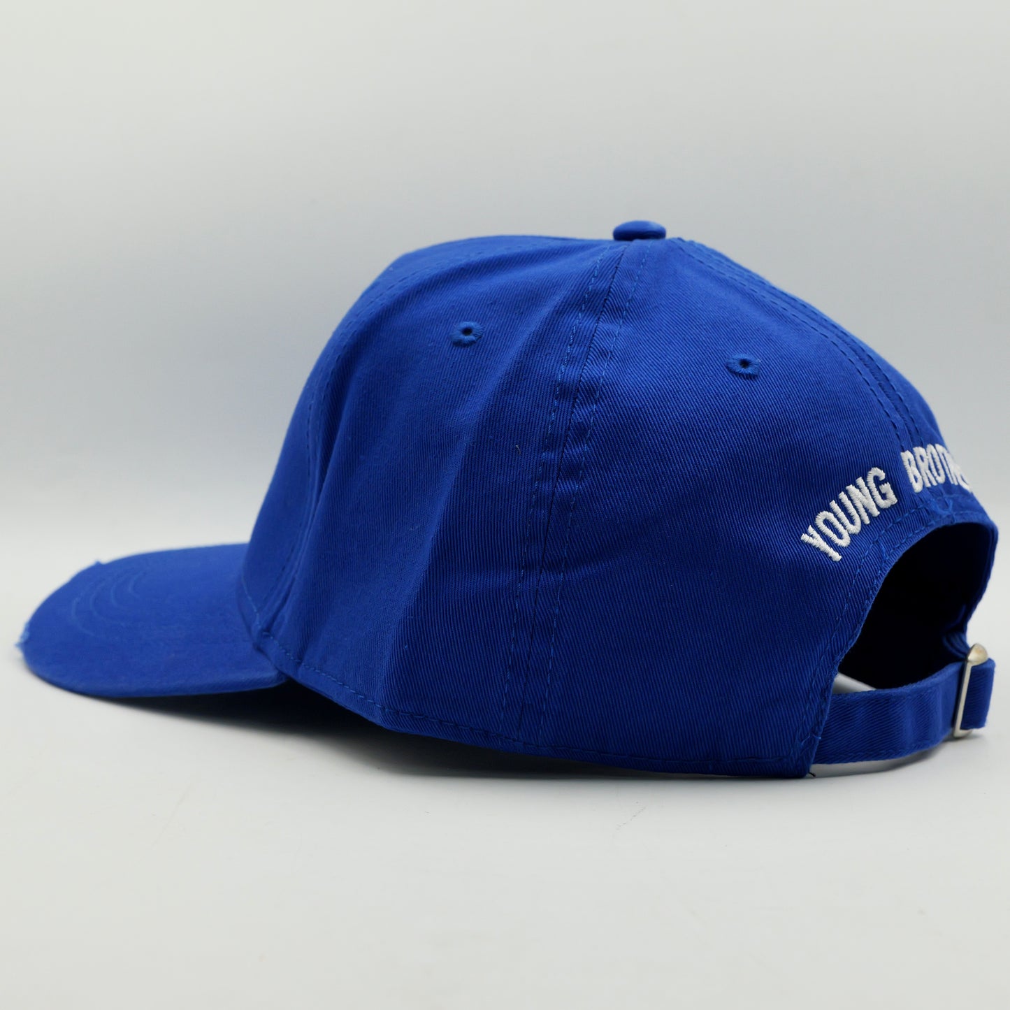 Blue cap with 'Young Bro' text on a light gray background