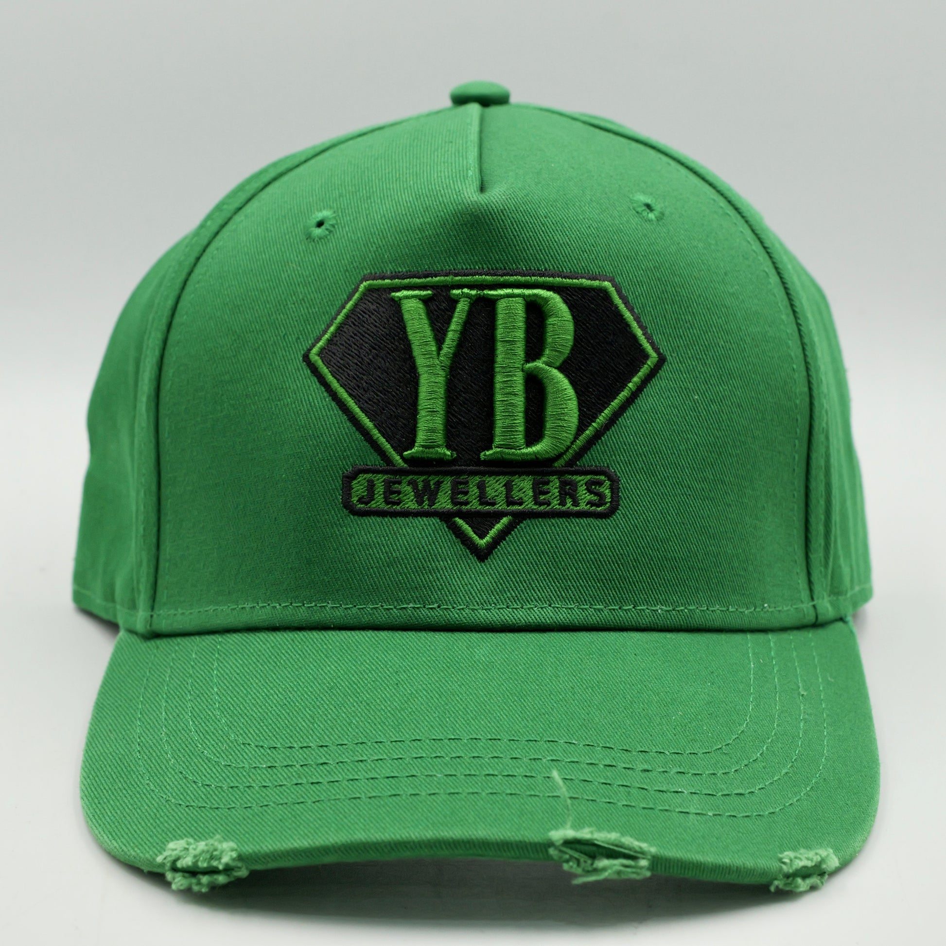 Green cap with 'YB Jewelers' logo on a white background