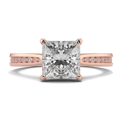 Rose gold ring with a large diamond and smaller diamonds on the band against a white background Yb jewellers engagement ring straight band
