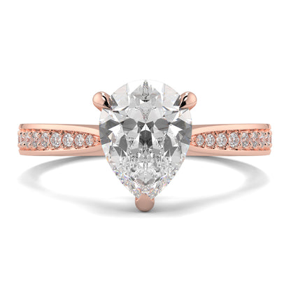 Rose gold ring with a pear-shaped diamond and smaller diamonds on a white background Yb jewellers engagement ring straight band