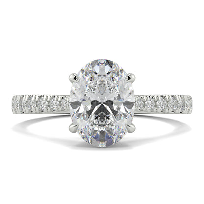 Diamond ring with a large central gemstone and smaller stones on the band against a white background Yb jewellers engagement ring straight band