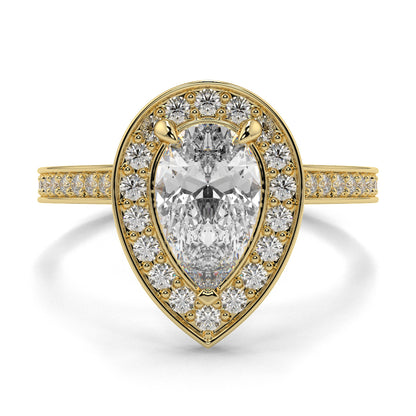Gold ring with a pear-shaped diamond and smaller diamonds on a white background Pear shaped diamond engagement ring Yb jewellers trending ring designs