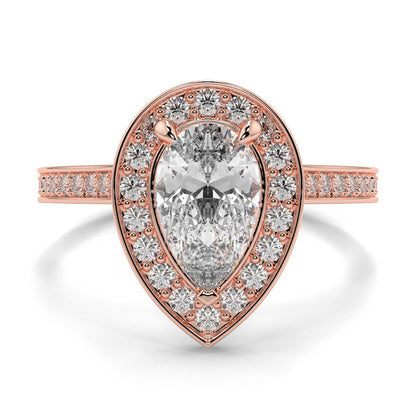 Rose gold ring with a pear-shaped diamond and smaller diamonds on a white background Pear shaped diamond engagement ring Yb jewellers trending ring designs