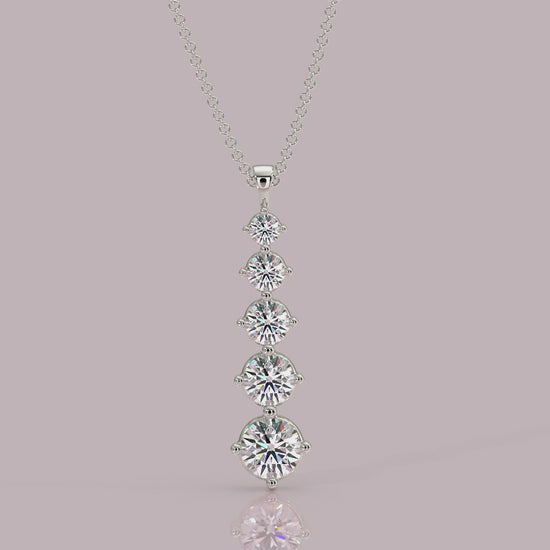 Close‑up: Aurora pendant showing 4‑claw setting and graduated round brilliant diamonds