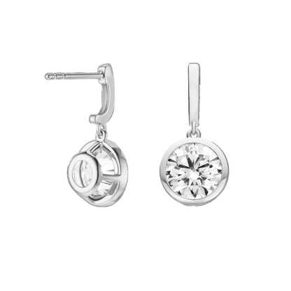 Silver earrings with clear gemstones on a green background